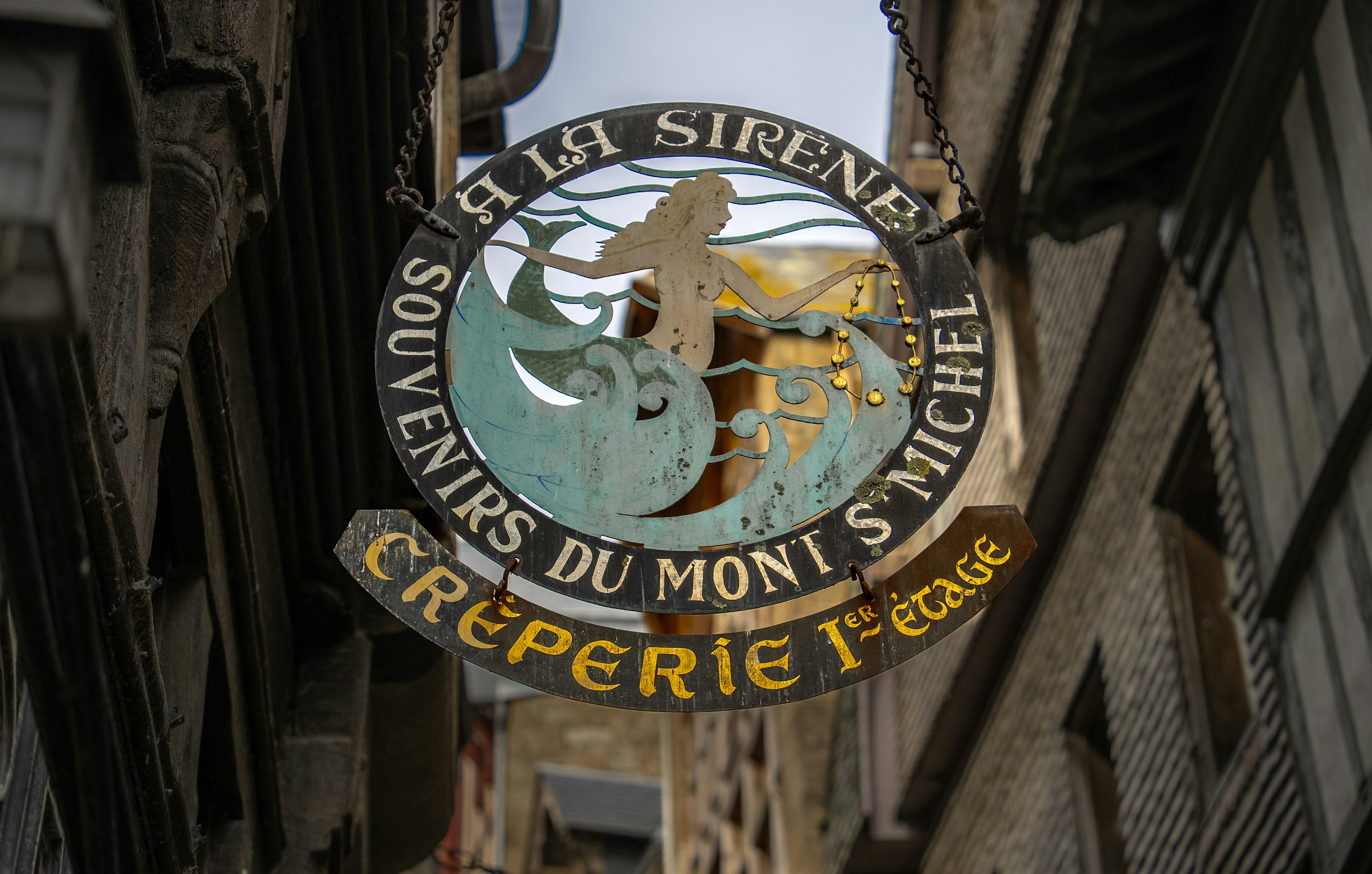 a sign hanging from the side of a building