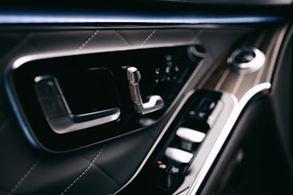 Close-up of elegant car interior highlighting fine materials and design.