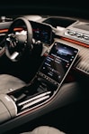 a car dashboard with a cell phone in the center
