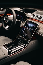 a car dashboard with a cell phone in the center