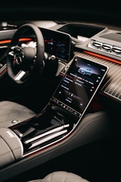 a car dashboard with a cell phone in the center