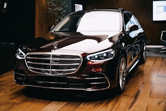 a black car parked on a wooden floor