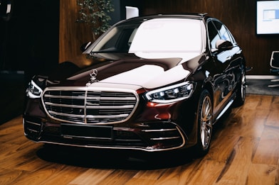 a black car parked on a wooden floor