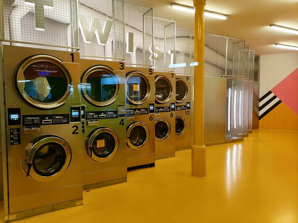 a row of washing machines in a public laundment