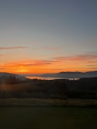 A serene landscape painting depicting a sunset.