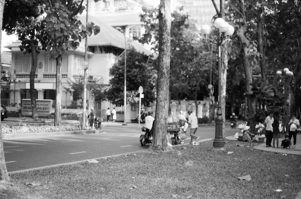 a black and white photo of people walking down a street