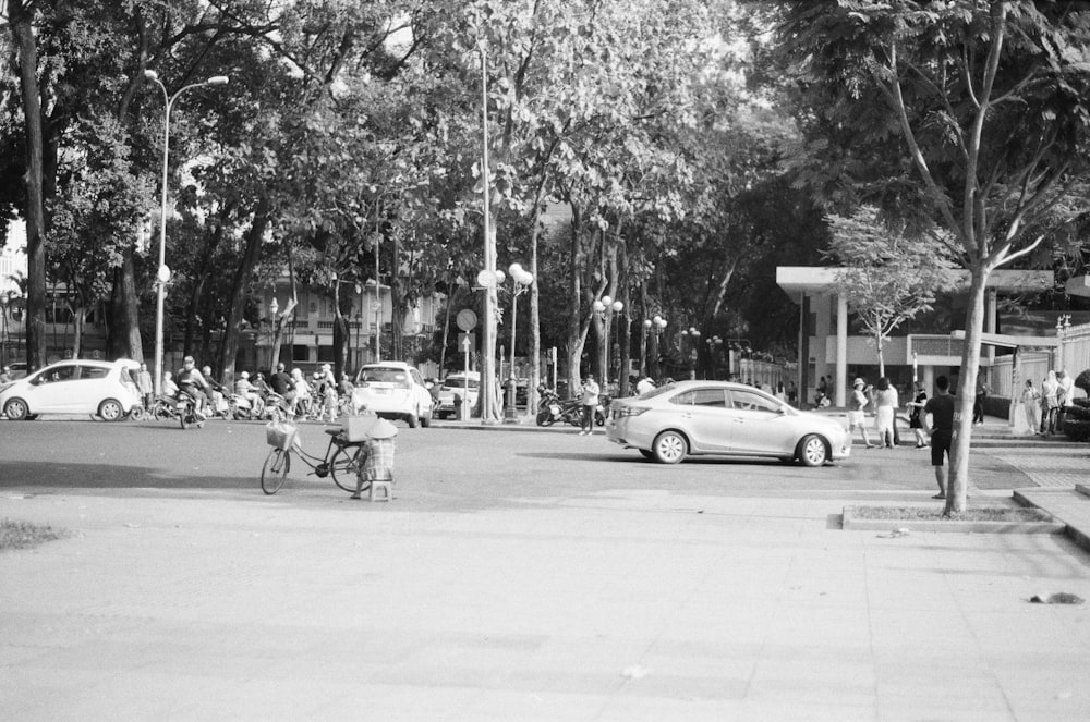 a black and white photo of a person riding a bike