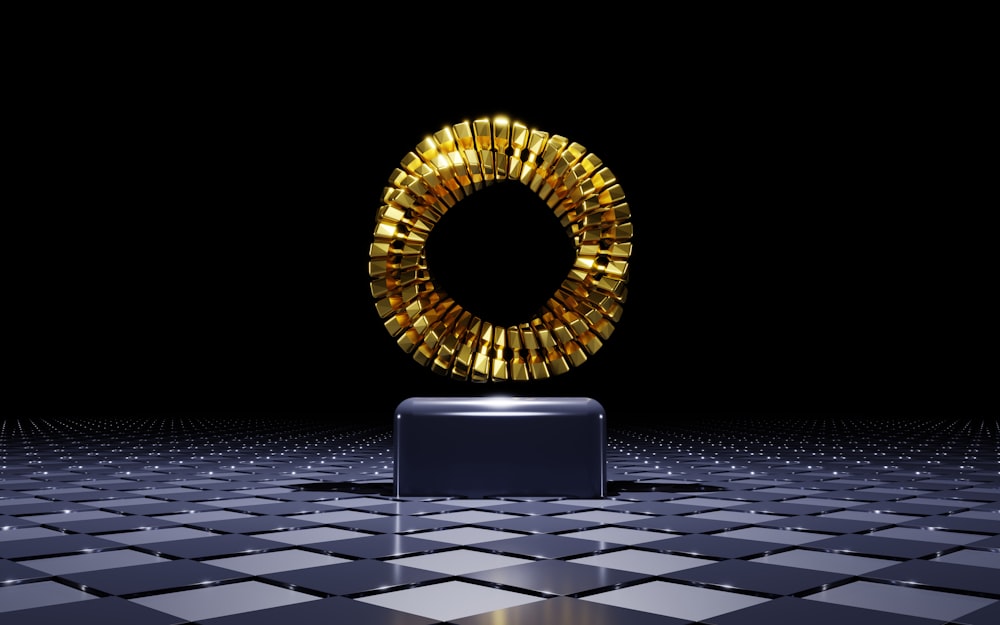 a golden object on a black and white tiled floor