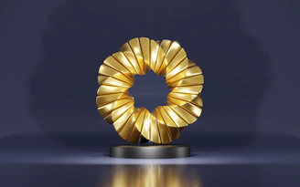 a golden object on a black stand on a blue background