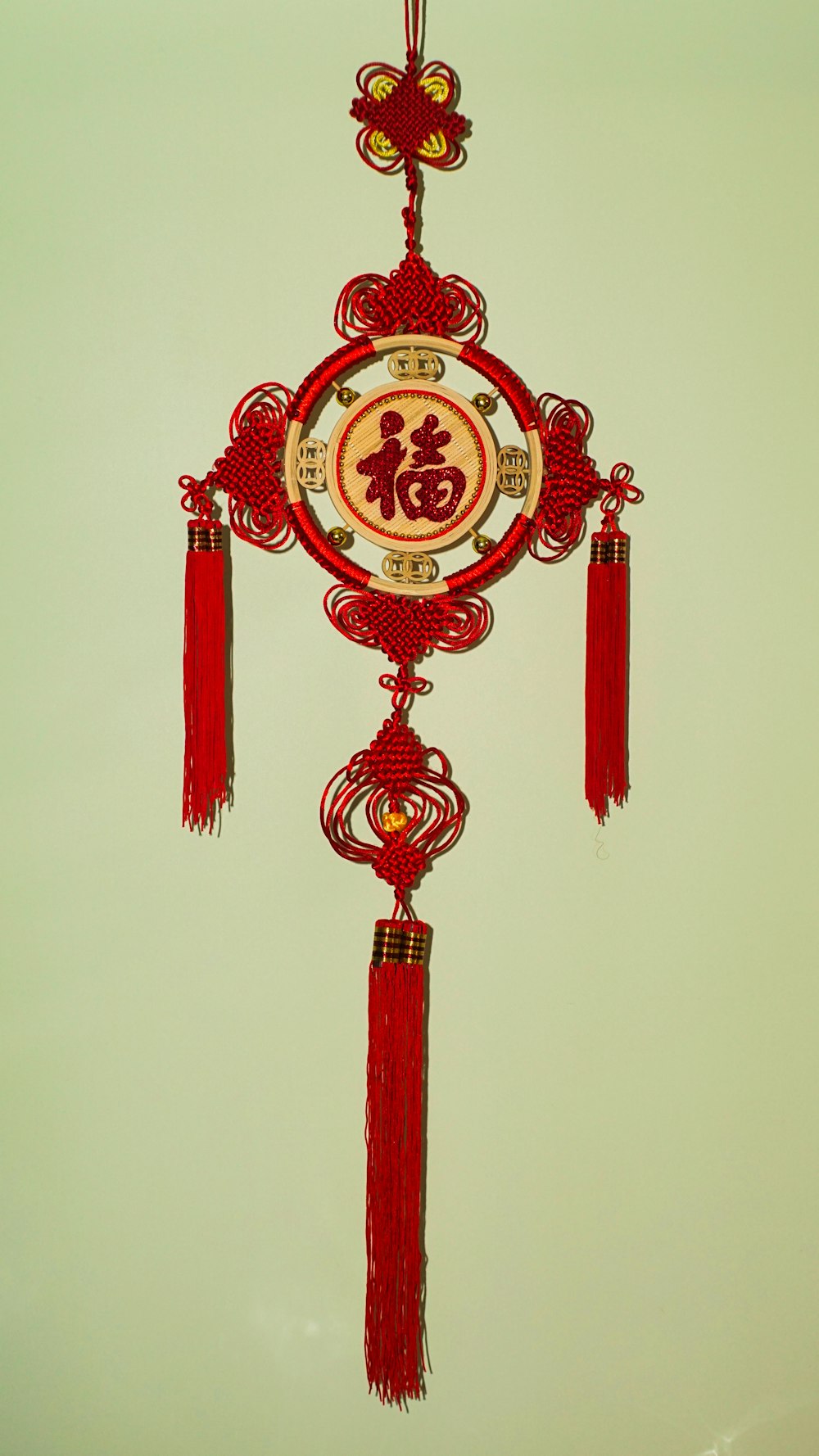 a red and white clock hanging from a ceiling