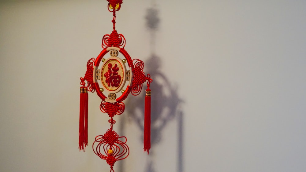 a red clock hanging from the side of a wall