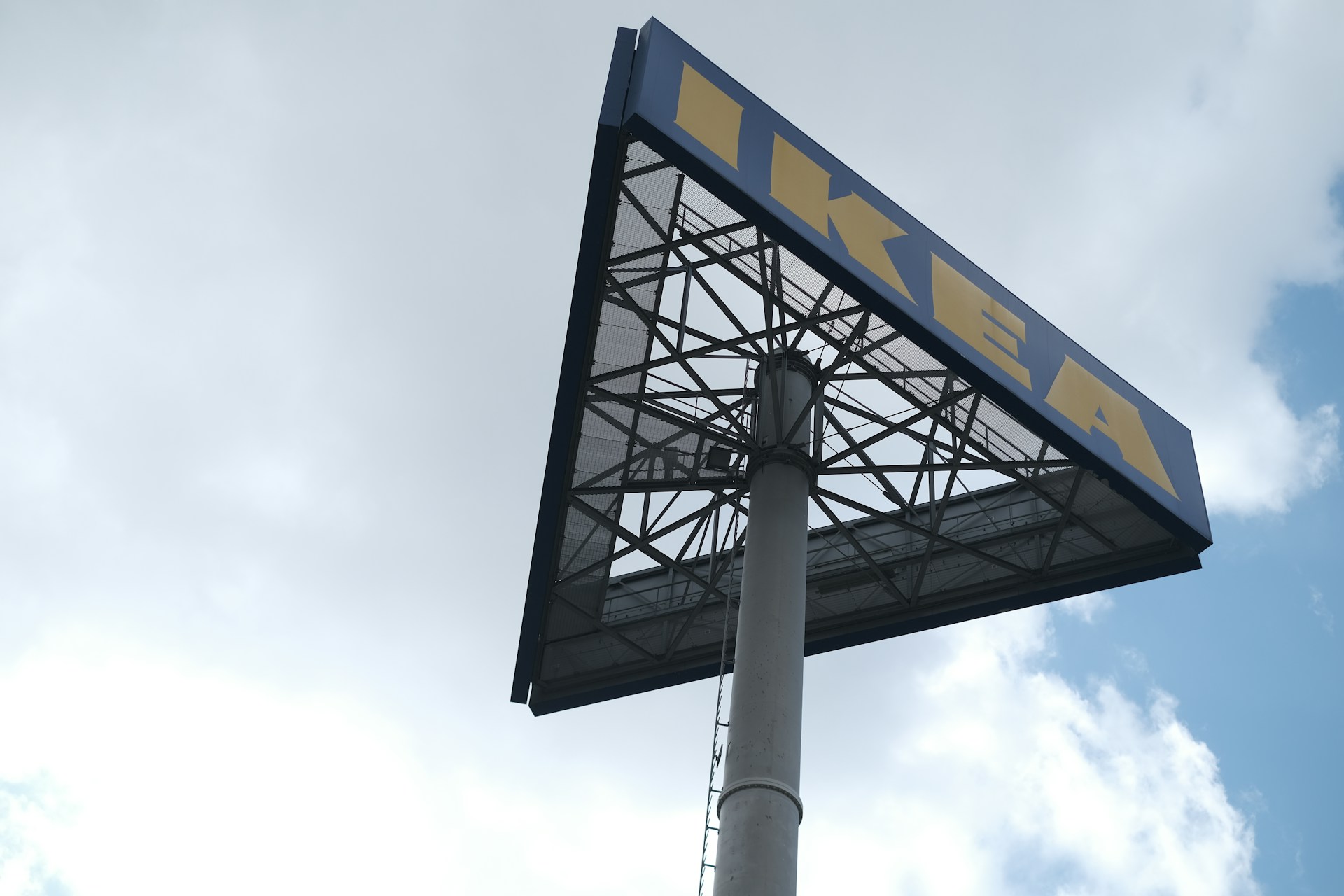 a large sign on top of a metal pole