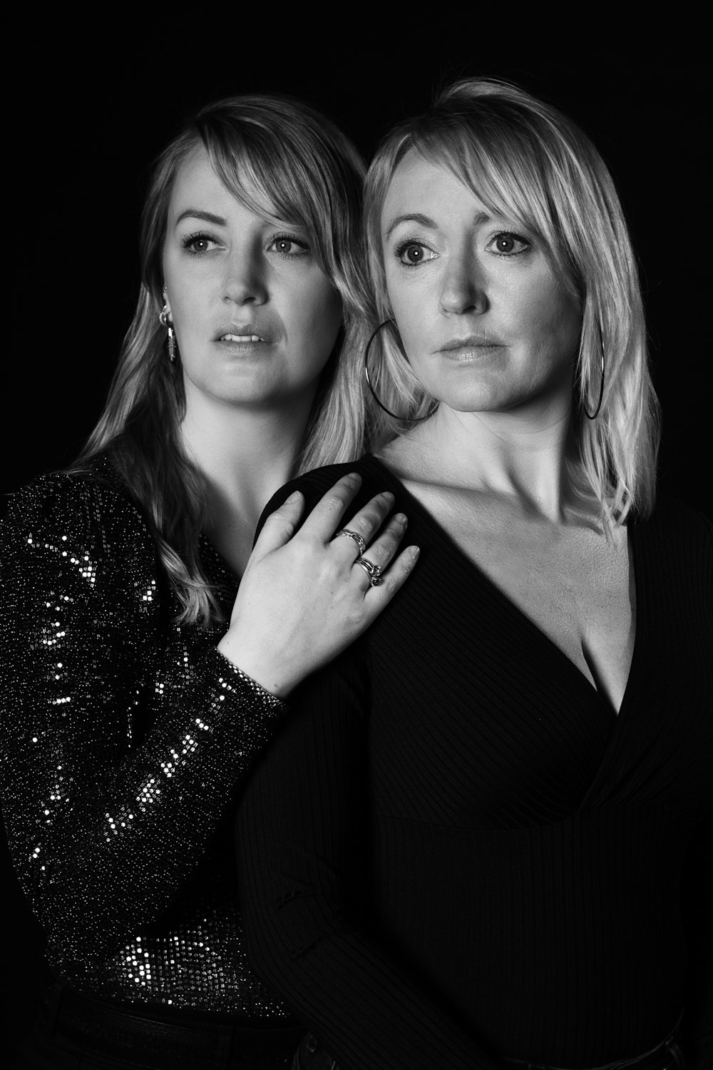 two women are posing for a black and white photo