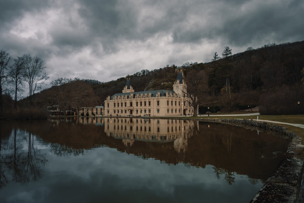 a large building sitting on top of a lake