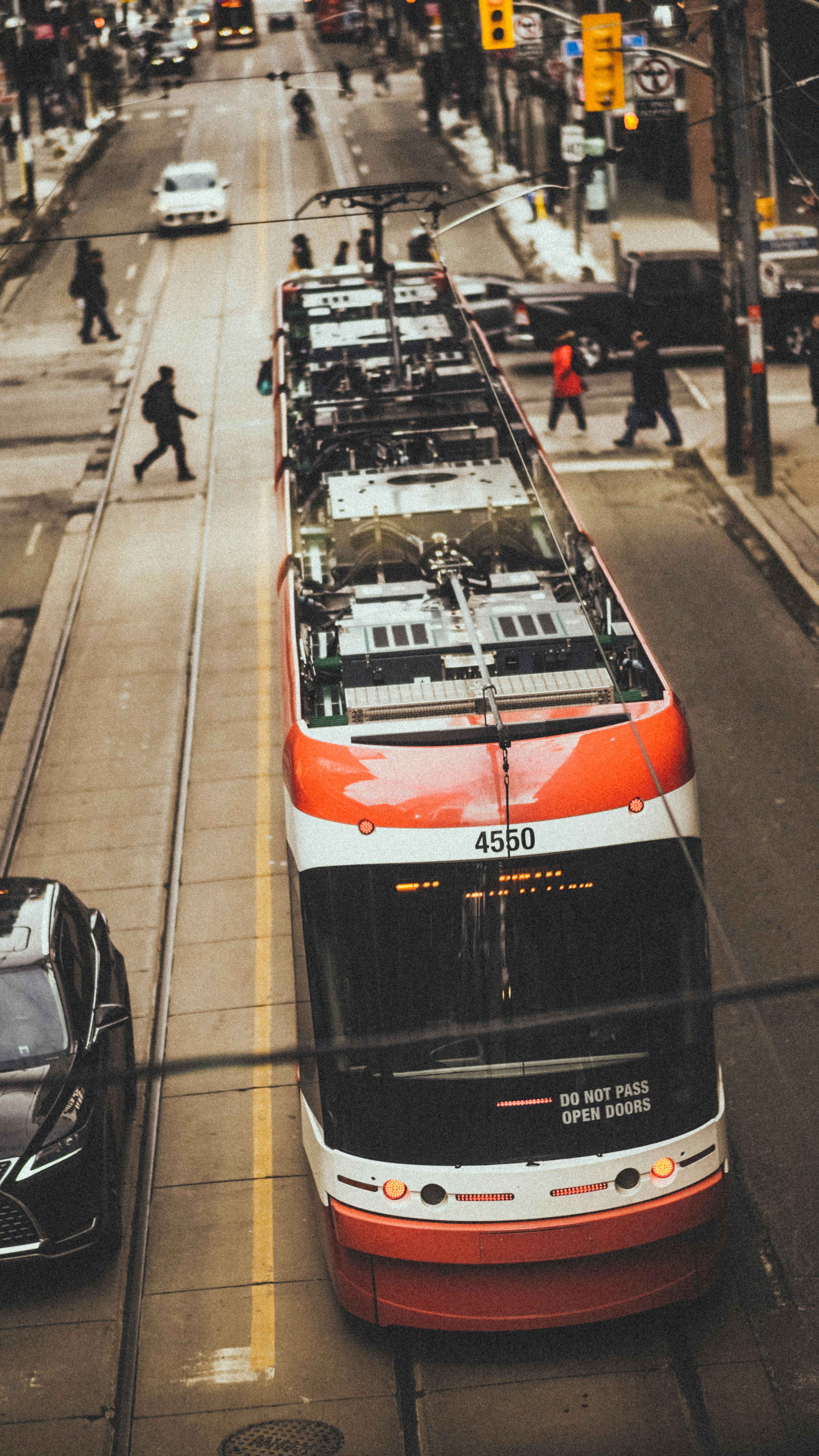 a red and white bus parked on the side of a road