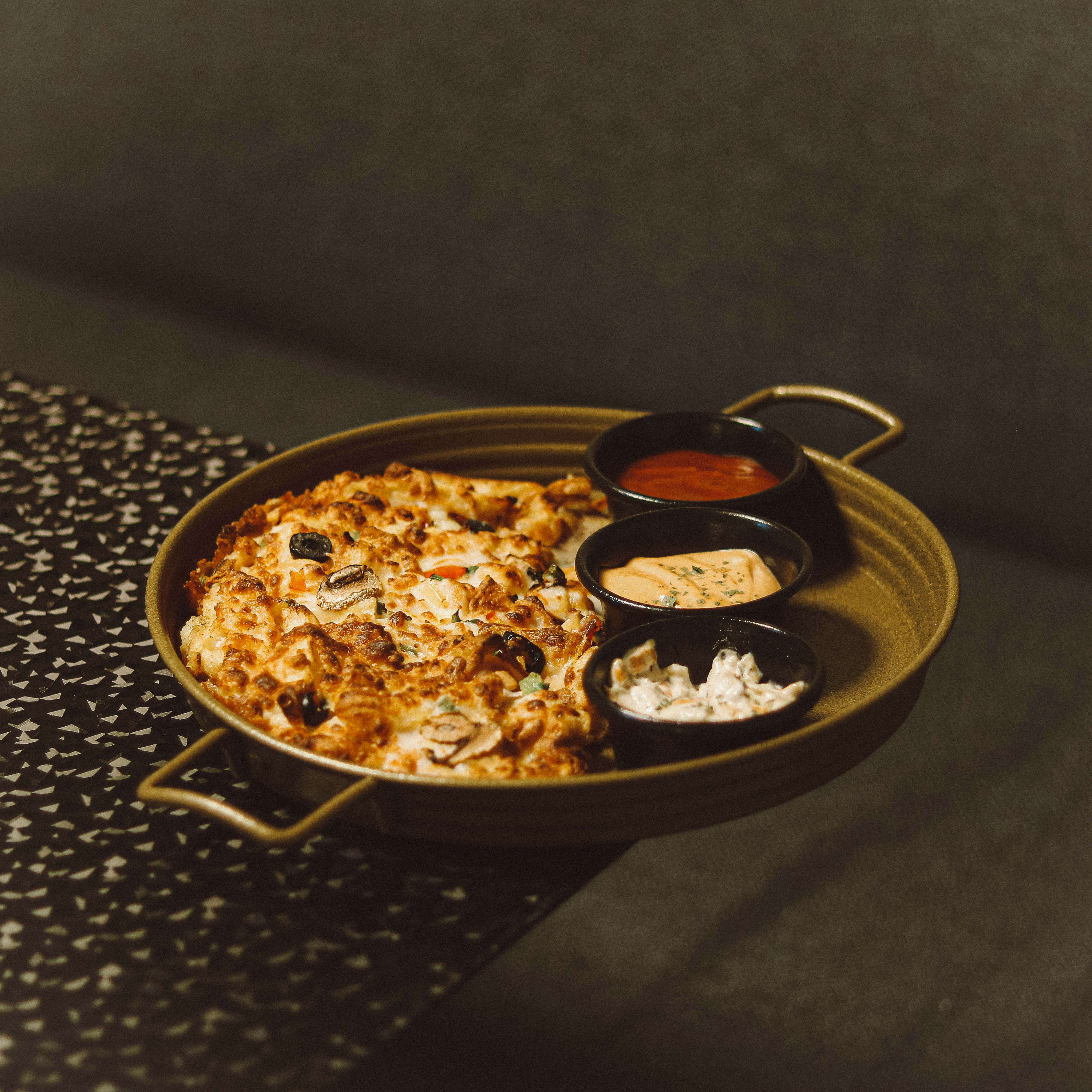 a plate of food on a table with sauces and condiments