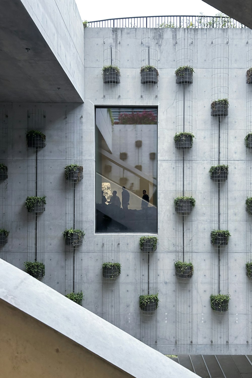 a building that has a bunch of planters on the side of it