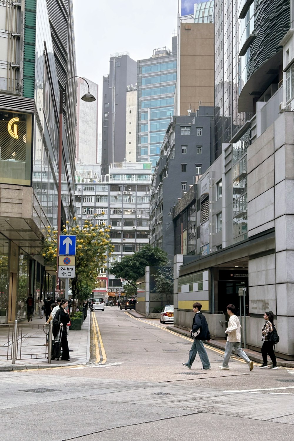 a group of people crossing a street in a city