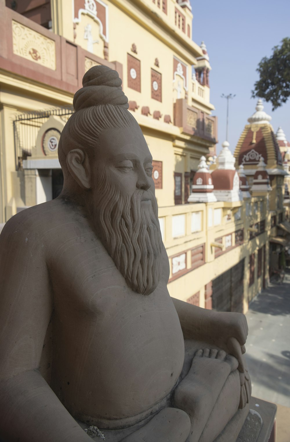 a statue of a man sitting in front of a building