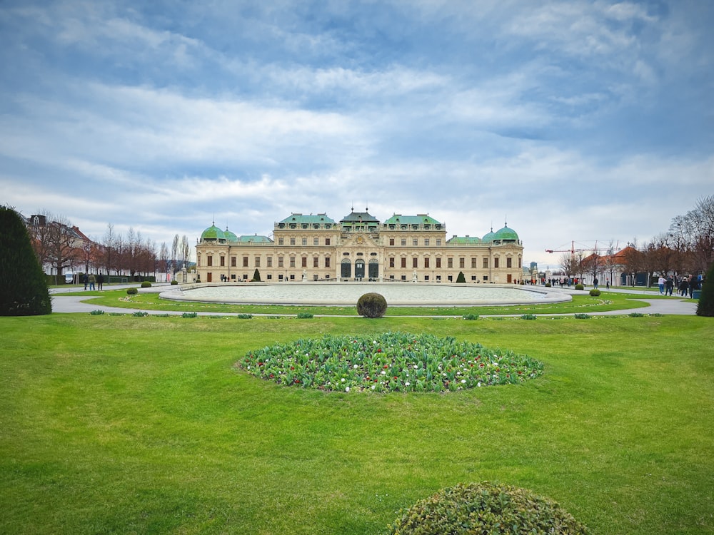 a large building sitting on top of a lush green field