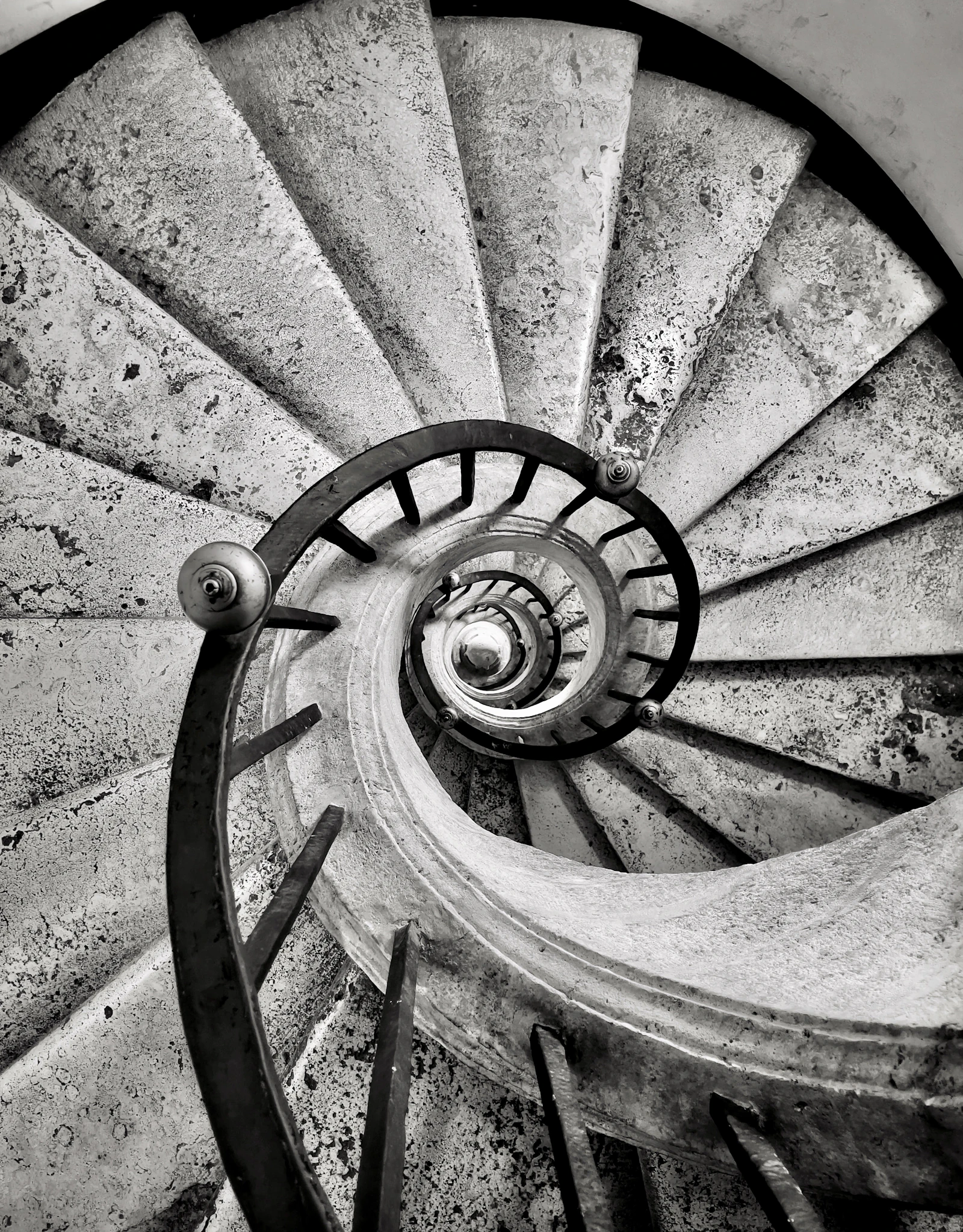 A black and white photo of a spiral staircase