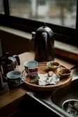 A kitchen counter displaying thoughtfully arranged gadgets and a steaming mug of tea.