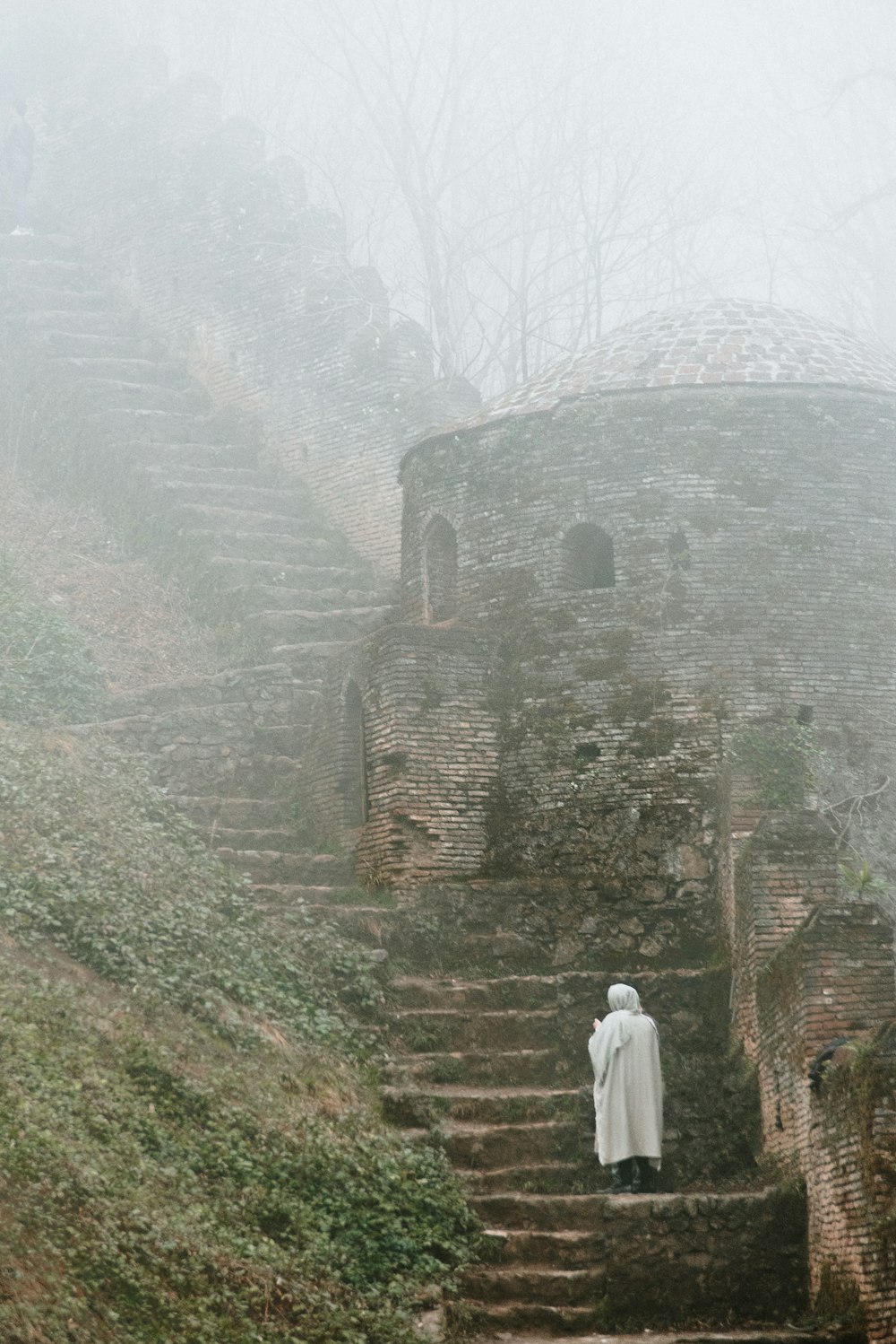 a person in a white robe standing on a set of stairs