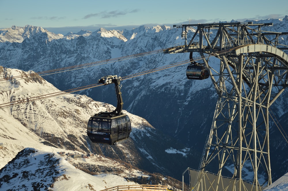 a ski lift going up a snowy mountain