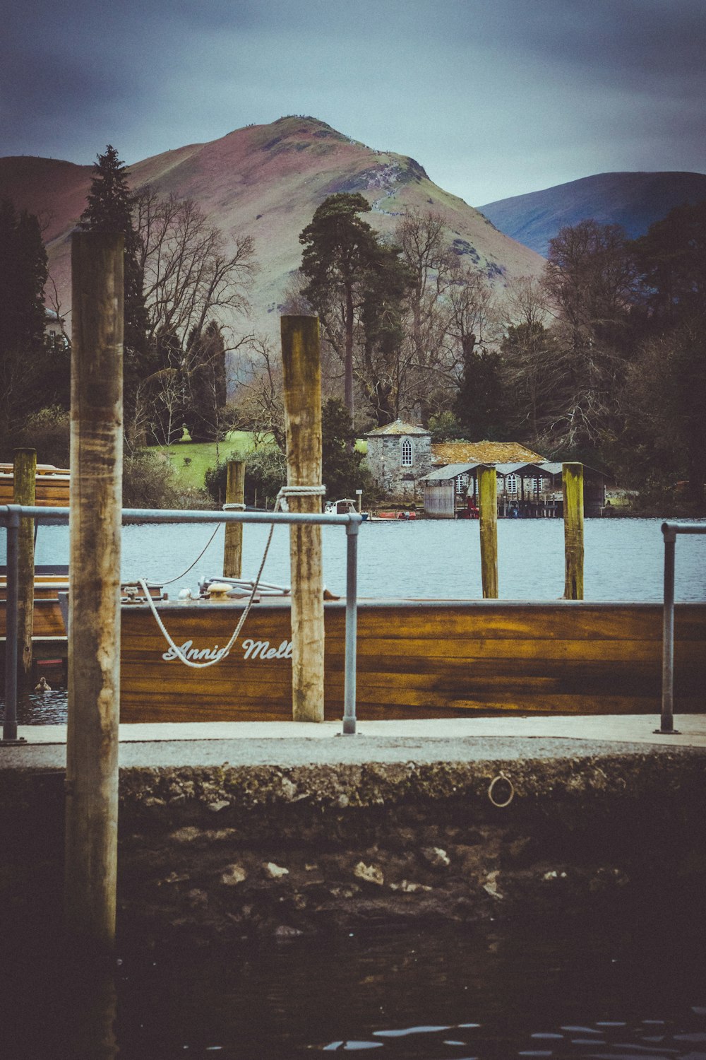 a wooden dock with a boat tied to it