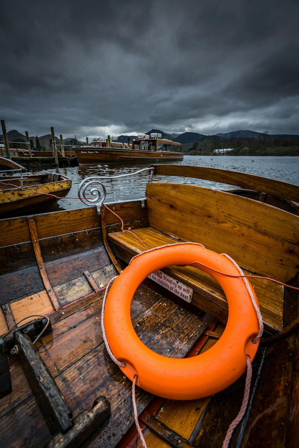 an orange life preserver on a wooden boat