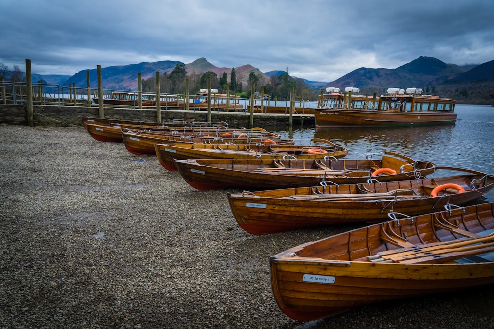 eine Reihe von Holzbooten, die auf einem See sitzen