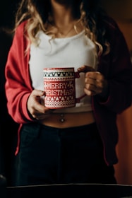A happy customer holding a personalized mug with a Christmas-themed design.