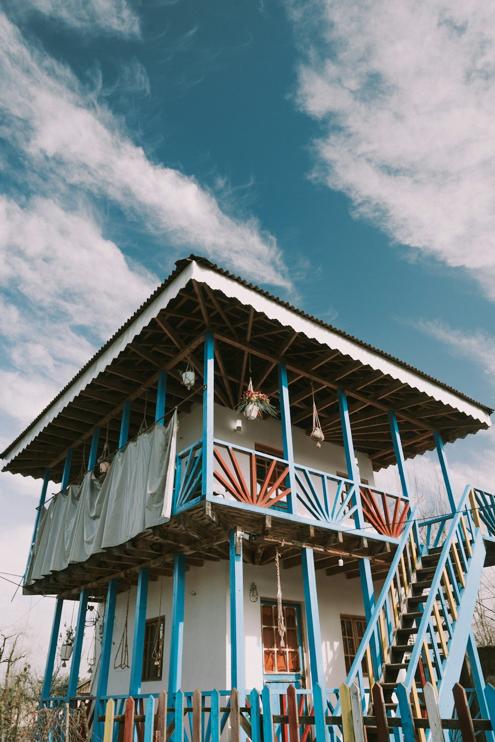 a blue and white house with a balcony