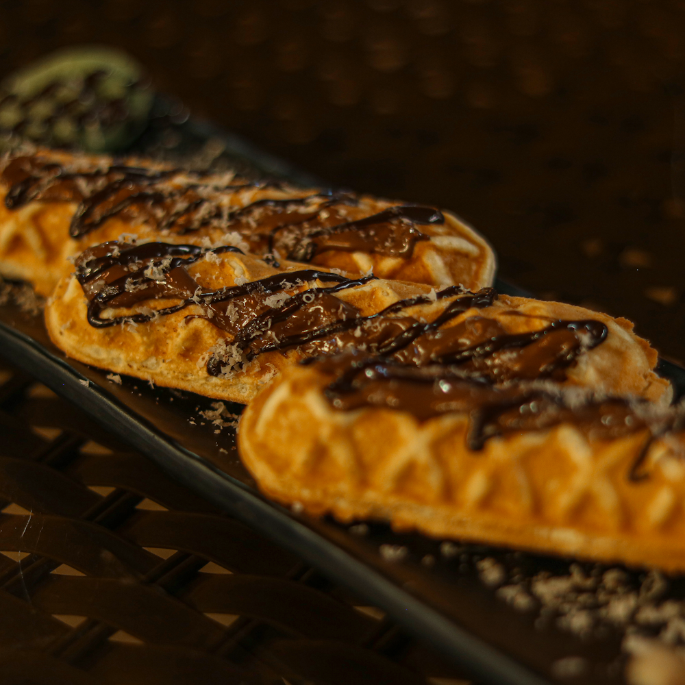 a row of waffles with chocolate drizzled on them