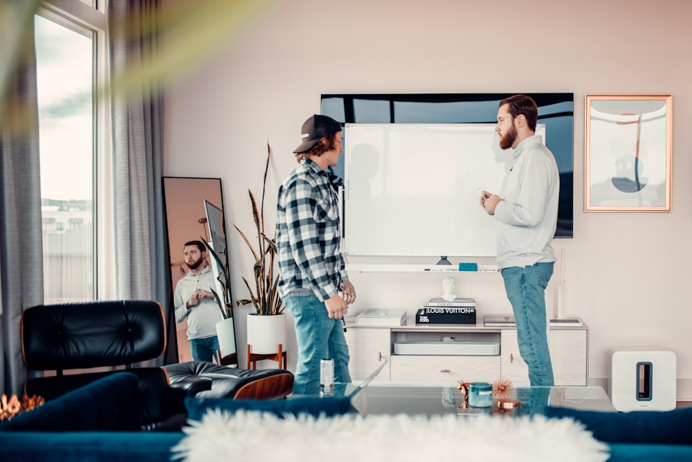 a couple of men standing in a living room