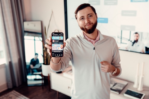 A close-up of a professional man confidently presenting his personal profile on a sleek digital device.