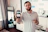 Photo of a confident man holding a smartphone displaying a digital business card