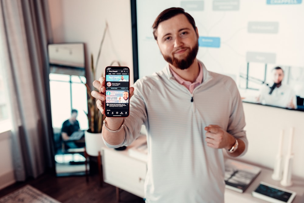 a man holding up a smart phone in his hand