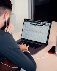 a man sitting in front of a laptop computer