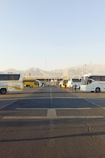 A fleet of Redline Coaches vehicles lined up under a clear sky, ready for UK tours and events.