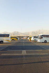 Spacious parking area with a bus and tempo traveller parked, ready for group arrivals.