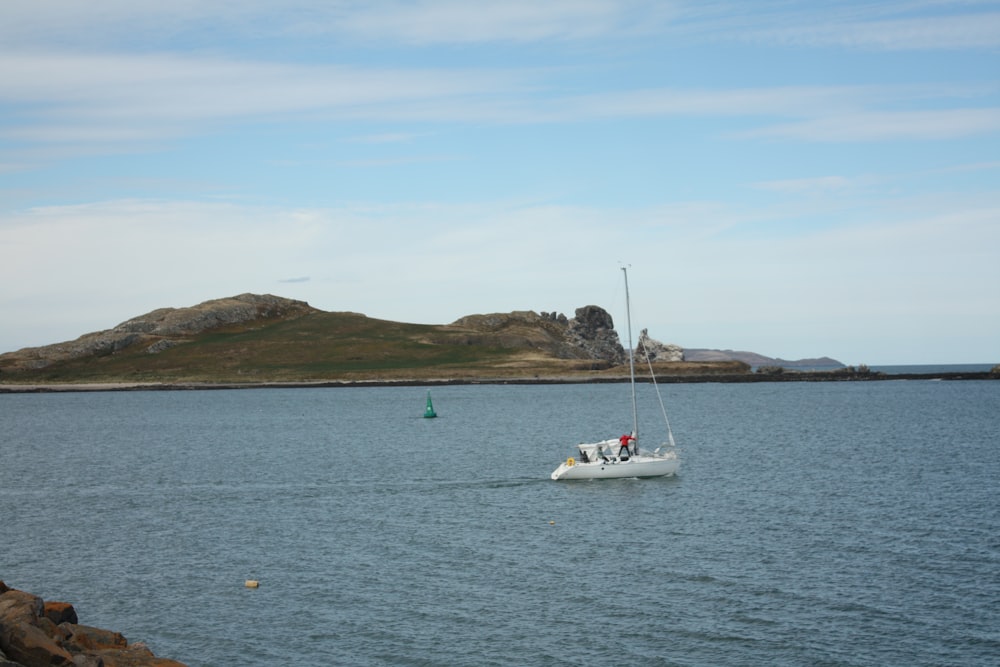 a sailboat in the middle of a body of water