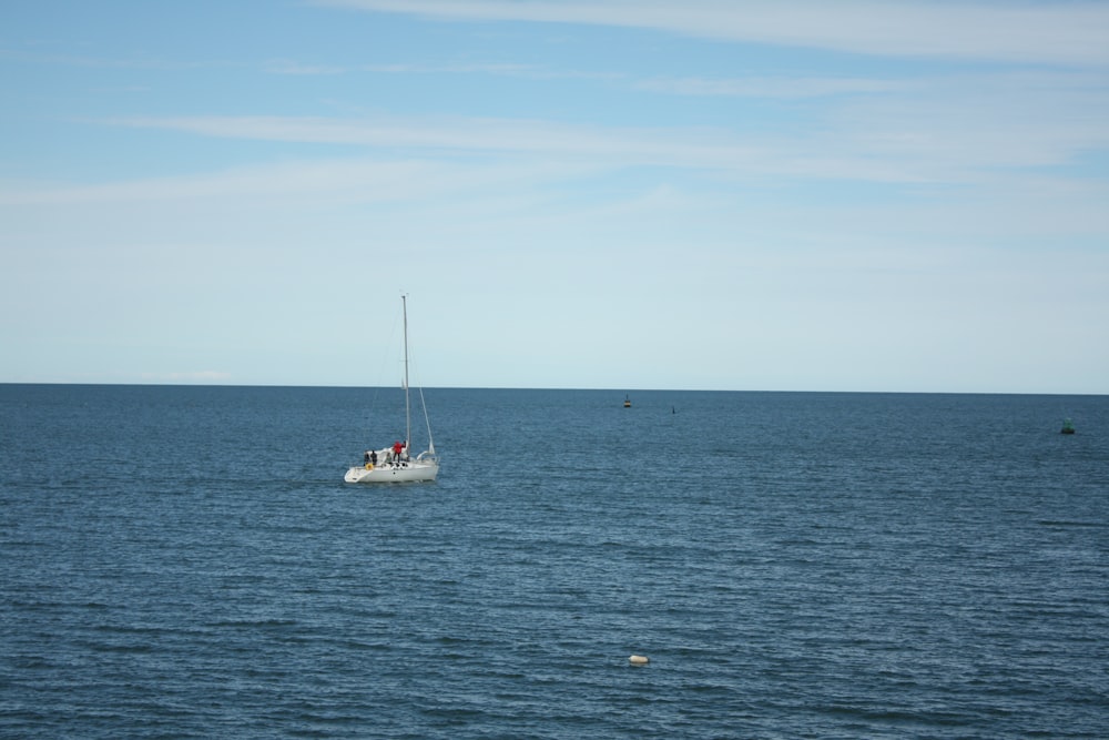 a small boat in the middle of a large body of water