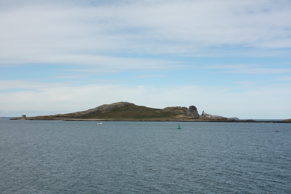 a body of water with a small island in the distance