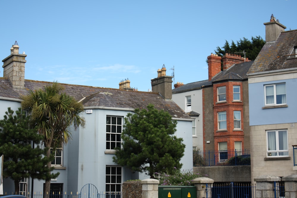 a row of houses with a gate in front of them