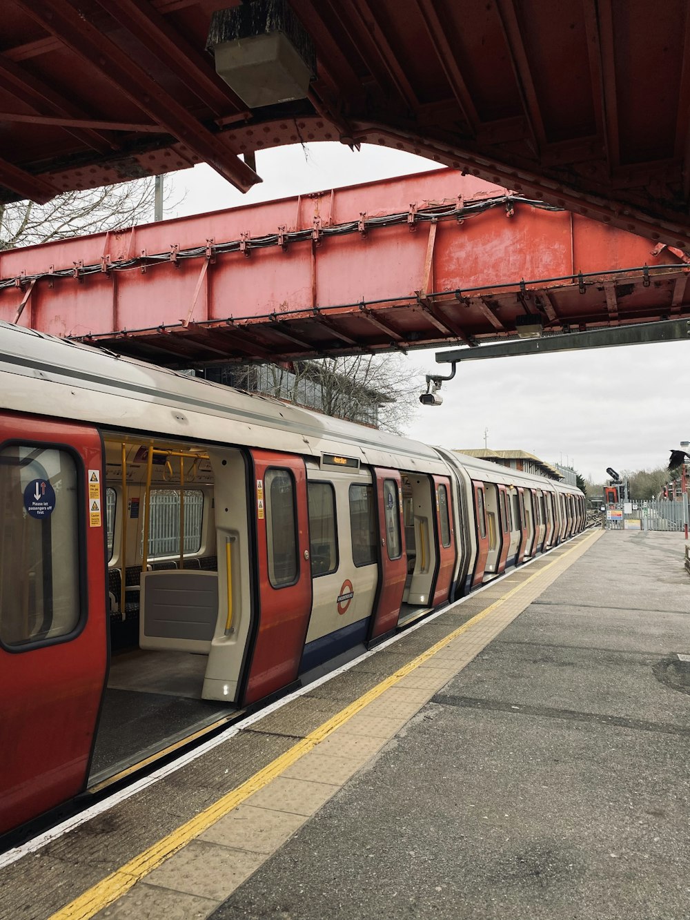 a red and white train pulling into a train station