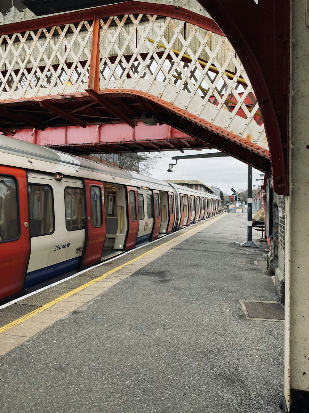 a red and white train pulling into a train station