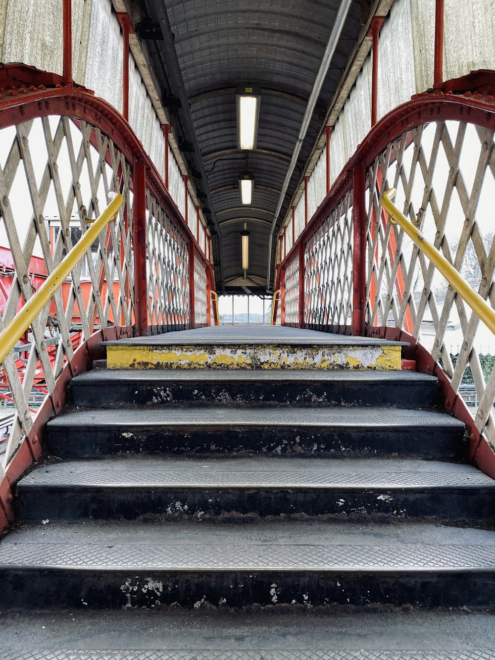 a set of stairs leading up to a train station