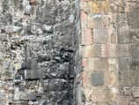 Close-up of ancient stone walls partially uncovered during an urban archaeological dig in Portugal.