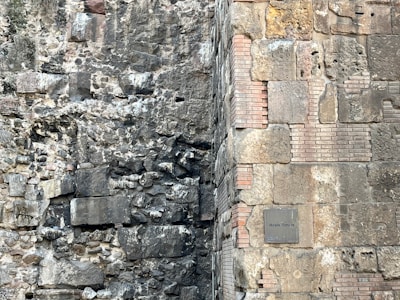 Close-up of ancient stone walls partially uncovered during an urban archaeological dig in Portugal.